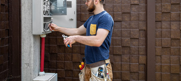 Electrician Builder Work Examines Cable Connection Electrical Line Fuselage Industrial Switchboard Professional Overalls With Electrician's Tool