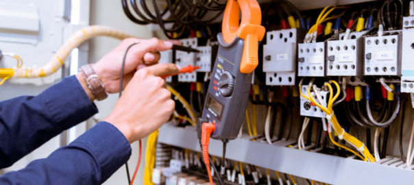 A person diligently working on electrical equipment, ensuring safety and efficiency. Trust Yarraville's commercial electricians for transformative benefits.